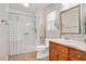 Bathroom featuring a white shower, a white toilet and a wooden vanity with mirror at 1117 Country Brooke Dr, Raleigh, NC 27603
