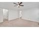 Bright bedroom featuring neutral carpet, ceiling fan, and entrances to the closet and bathroom at 1117 Country Brooke Dr, Raleigh, NC 27603