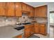 Well-designed kitchen with stainless steel appliances, neutral countertops, and rich wood cabinets at 1117 Country Brooke Dr, Raleigh, NC 27603