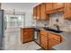 Updated kitchen featuring stainless steel appliances, tile flooring, and warm wood cabinetry at 1117 Country Brooke Dr, Raleigh, NC 27603
