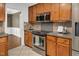 Modern kitchen with stainless steel appliances, stylish backsplash, and abundant cabinet space at 1117 Country Brooke Dr, Raleigh, NC 27603