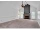 Spacious living room features a vaulted ceiling, brick fireplace, and ample natural light from the french doors at 1117 Country Brooke Dr, Raleigh, NC 27603