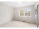 Well-lit bedroom with neutral colored carpet and two windows at 116 Marlowe Court Ct, Carrboro, NC 27510