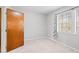 This bedroom features neutral carpet, walls, trim, and a window with bright natural light at 116 Marlowe Court Ct, Carrboro, NC 27510