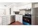 Well-lit kitchen features a stainless steel dishwasher, a range, and light countertops at 116 Marlowe Court Ct, Carrboro, NC 27510