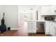 View from living room into the kitchen with stainless steel dishwasher and white cabinets at 116 Marlowe Court Ct, Carrboro, NC 27510