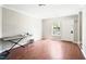 Bright living room featuring hardwood floors, white walls, and a large window allowing natural light at 116 Marlowe Court Ct, Carrboro, NC 27510