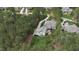 Beautiful home with a long, private driveway surrounded by dense trees and a lush lawn at 125 Dartmoor Ln, Raleigh, NC 27614