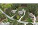 Scenic aerial view of multiple homes with long driveways, lush landscaping, and mature trees at 125 Dartmoor Ln, Raleigh, NC 27614
