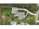 An aerial view of a backyard featuring an in-ground pool, a lounge area, and lush landscaping at 125 Dartmoor Ln, Raleigh, NC 27614