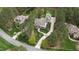 Aerial view of a home with a long driveway, surrounded by a dense forest at 125 Dartmoor Ln, Raleigh, NC 27614