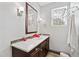 Elegant bathroom featuring a vanity with dark cabinets, quartz countertop, and modern fixtures at 125 Dartmoor Ln, Raleigh, NC 27614
