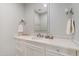 Stylish powder room featuring a decorative-tile countertop, a modern faucet, and charming vanity lighting fixtures at 125 Dartmoor Ln, Raleigh, NC 27614