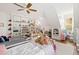 Bright bedroom features ceiling fan, twin beds and built-in bookshelves at 125 Dartmoor Ln, Raleigh, NC 27614
