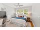 Bright bedroom featuring a ceiling fan, a large window, and views of the surrounding area at 125 Dartmoor Ln, Raleigh, NC 27614