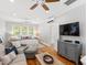 Spacious bedroom area with wood floors, ceiling fans, a sitting area, and a large window at 125 Dartmoor Ln, Raleigh, NC 27614