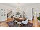 Charming dining room showcases a decorative rug, chandelier, and staircase at 125 Dartmoor Ln, Raleigh, NC 27614