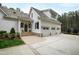 Charming three-car garage with a stone foundation and an elegant, white-painted exterior at 125 Dartmoor Ln, Raleigh, NC 27614