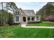 Charming stone and shingle home with inviting front porch and well-manicured lawn at 125 Dartmoor Ln, Raleigh, NC 27614