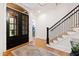 Welcoming foyer features hardwood floors, elegant staircase, and stylish double doors at 125 Dartmoor Ln, Raleigh, NC 27614