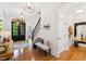 Bright foyer featuring hardwood floors, stylish bench, and an elegant staircase at 125 Dartmoor Ln, Raleigh, NC 27614