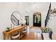 Inviting foyer featuring hardwood floors, stylish decor, and an elegant staircase at 125 Dartmoor Ln, Raleigh, NC 27614