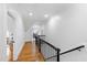 Upstairs hallway with hardwood floors and access to additional living spaces at 125 Dartmoor Ln, Raleigh, NC 27614