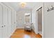 Hallway with a seating area, a window, wood floors, closet doors, and access to the bathroom at 125 Dartmoor Ln, Raleigh, NC 27614