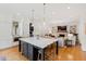 Spacious kitchen featuring a large island, modern appliances, and an open layout to the living room at 125 Dartmoor Ln, Raleigh, NC 27614