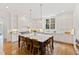 Bright, open kitchen with a large center island and white cabinets at 125 Dartmoor Ln, Raleigh, NC 27614