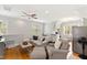 Cozy living area featuring hardwood floors, a ceiling fan, and a partial kitchen area at 125 Dartmoor Ln, Raleigh, NC 27614
