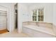 Beautiful main bathroom featuring soaking tub, large window and walk-in shower with glass door at 125 Dartmoor Ln, Raleigh, NC 27614