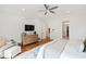 Open main bedroom with hardwood flooring, sitting area, TV, ensuite bathroom and walk-in closet at 125 Dartmoor Ln, Raleigh, NC 27614