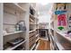 Walk-in pantry features built-in shelving, drawers, wine cooler, and ample storage space for groceries at 125 Dartmoor Ln, Raleigh, NC 27614