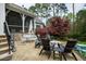 Outdoor stone patio is nicely arranged with comfortable seating around a fire pit, perfect for gathering at 125 Dartmoor Ln, Raleigh, NC 27614