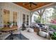 Inviting covered porch offering a lounge area, dining space, ceiling fan, and views of the surrounding yard at 125 Dartmoor Ln, Raleigh, NC 27614