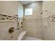 Tiled walk-in shower with a bench, handheld showerhead and standard showerhead at 125 Dartmoor Ln, Raleigh, NC 27614