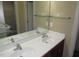 Bathroom featuring a double vanity sink with a large mirror and updated hardware at 126 Creedmoor Rd, Stem, NC 27581