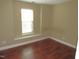Bedroom with wood floors, neutral walls, and window with white blinds at 126 Creedmoor Rd, Stem, NC 27581