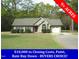 Charming single-story home with a well-manicured lawn and attached garage on over 9 acres at 126 Creedmoor Rd, Stem, NC 27581