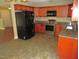 Well-equipped kitchen with granite countertops and stainless steel appliances adjacent to a spacious living area at 126 Creedmoor Rd, Stem, NC 27581