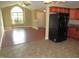 Open floor plan shows the kitchen with black refrigerator and adjacent living area at 126 Creedmoor Rd, Stem, NC 27581