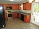 This home features a well-equipped kitchen with stainless steel appliances and granite countertops at 126 Creedmoor Rd, Stem, NC 27581