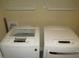 This home has a laundry room with two modern, front-loading washing machines at 126 Creedmoor Rd, Stem, NC 27581