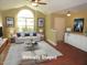 Bright living room boasts a large window, vaulted ceiling, and neutral decor, creating a welcoming space at 126 Creedmoor Rd, Stem, NC 27581
