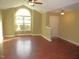 Bright living room features a large window and vaulted ceiling at 126 Creedmoor Rd, Stem, NC 27581