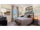 Comfortable bedroom with soft natural light, gray and white striped walls, and decorative artwork at 1260 Hazelnut Ridge Ln, Knightdale, NC 27545
