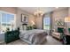 Elegant bedroom with a chandelier, sitting area, and large windows providing ample natural light at 1260 Hazelnut Ridge Ln, Knightdale, NC 27545