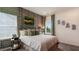 Charming bedroom with rustic wood accent wall, comfortable bed, and decorative window treatments at 1260 Hazelnut Ridge Ln, Knightdale, NC 27545