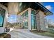 Contemporary building featuring a stone pillar, expansive windows, and outdoor patio, blending modern design with nature at 1260 Hazelnut Ridge Ln, Knightdale, NC 27545